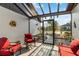 Enclosed front porch with seating, offering a view of the landscaped front yard and a secure entry at 667 Foxwood Blvd, Englewood, FL 34223
