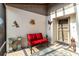 Comfortable front porch features a red bench, charming wall decor, and a cozy, welcoming atmosphere at 667 Foxwood Blvd, Englewood, FL 34223