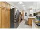 Well-lit kitchen with stainless steel appliances and a combination of white and wood cabinets at 667 Foxwood Blvd, Englewood, FL 34223