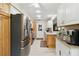 Bright kitchen with stainless steel appliances, wooden cabinets, and ample counter space at 667 Foxwood Blvd, Englewood, FL 34223