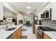 Bright kitchen leading to office and dining area with stainless steel appliances and tile backsplash at 667 Foxwood Blvd, Englewood, FL 34223