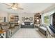 Spacious living room boasts a ceiling fan, stylish decor, comfortable seating, and natural light at 667 Foxwood Blvd, Englewood, FL 34223