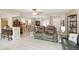 Open-concept living space with a ceiling fan, modern furniture, and a glimpse of the adjacent kitchen and dining area at 667 Foxwood Blvd, Englewood, FL 34223