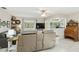 Relaxing living room with a ceiling fan, entertainment center, and a pass-through to the adjacent breakfast bar at 667 Foxwood Blvd, Englewood, FL 34223