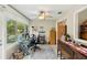 Bright office space with large windows, ceiling fan, and light wood flooring, ideal for working from home at 667 Foxwood Blvd, Englewood, FL 34223
