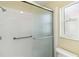 Close up view of a modern shower featuring updated showerhead and glass door at 667 Foxwood Blvd, Englewood, FL 34223