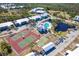 Birds eye view showcasing tennis courts, pool, bocce ball court, and community buildings at 6800 Placida Rd # 262, Englewood, FL 34224
