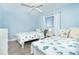 Bright bedroom featuring two twin beds with nautical-themed bedding and a ceiling fan at 6800 Placida Rd # 262, Englewood, FL 34224