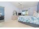 Bright bedroom featuring natural light, a ceiling fan, and view of the lanai at 6800 Placida Rd # 262, Englewood, FL 34224