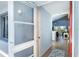 Bright entryway featuring wood-look flooring, a blue accent wall, and views into the open-concept living space at 6800 Placida Rd # 262, Englewood, FL 34224