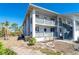 Exterior corner unit with a ground-level patio and second-floor balcony with direct access to the unit at 6800 Placida Rd # 262, Englewood, FL 34224
