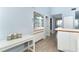 Hallway has light-blue walls, and a glass shelving unit with countertop below at 6800 Placida Rd # 262, Englewood, FL 34224