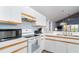 Kitchen with stainless steel microwave, white appliances, and counterspace at 6800 Placida Rd # 262, Englewood, FL 34224