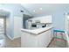 Efficient kitchen with white cabinets, wood look flooring, and plenty of natural light at 6800 Placida Rd # 262, Englewood, FL 34224