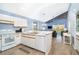 Open-concept kitchen with white cabinets, an island, and an open view into the living room and balcony at 6800 Placida Rd # 262, Englewood, FL 34224