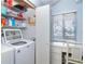 Bright laundry room features a washing machine, dryer and shelving for organized storage at 6800 Placida Rd # 262, Englewood, FL 34224