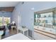 Light-blue living room with glass shelving unit and view to a balcony at 6800 Placida Rd # 262, Englewood, FL 34224