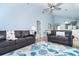 Spacious living room features leather sofas and a ceiling fan at 6800 Placida Rd # 262, Englewood, FL 34224