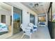 Comfortable screened porch with white wicker furniture and a peaceful view off the Primary bedroom at 6800 Placida Rd # 262, Englewood, FL 34224