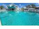 Large in-ground community pool offers clear water and comfortable seating, adjacent to a clubhouse at 6800 Placida Rd # 262, Englewood, FL 34224