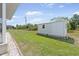 Spacious backyard with lush green grass and a utility shed at 7089 Benson St, Englewood, FL 34224