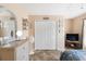 Bright bedroom with tile floors, ceiling fan, and double door closet at 7089 Benson St, Englewood, FL 34224