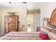 Comfortable bedroom featuring tile floors and a view into the ensuite bathroom creating a tranquil retreat at 7089 Benson St, Englewood, FL 34224