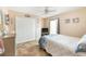 Comfortable bedroom featuring a bed with floral bedding, a ceiling fan, and a closet at 7089 Benson St, Englewood, FL 34224
