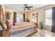 Comfortable bedroom with tile floors, a ceiling fan, and natural light creating a warm and inviting atmosphere at 7089 Benson St, Englewood, FL 34224