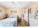 Cozy bedroom showcasing tile floors, wicker furniture, and a bed with blue floral bedding at 7089 Benson St, Englewood, FL 34224