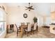 Dining area featuring tile flooring, a ceiling fan, and natural light creating an inviting space for gatherings at 7089 Benson St, Englewood, FL 34224