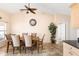 Dining area featuring tile flooring, a ceiling fan, and natural light, creating an inviting space for meals at 7089 Benson St, Englewood, FL 34224