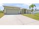 Beautiful single-story home with a two-car garage and well-maintained landscaping at 7089 Benson St, Englewood, FL 34224