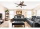 Comfortable living room featuring tile floors, a decorative ceiling fan, and stylish furnishings at 7089 Benson St, Englewood, FL 34224