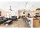 Bright living area with an open layout featuring a kitchen island with barstools and a comfortable living space at 7089 Benson St, Englewood, FL 34224