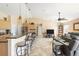 Inviting living space showcasing a kitchen island with seating and a living room with comfortable furnishings at 7089 Benson St, Englewood, FL 34224