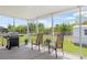 The screened-in patio has a grill and seating to enjoy the outdoor views at 7089 Benson St, Englewood, FL 34224
