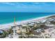 Scenic aerial view showcasing a beachfront property with a pond and a nearby road amidst lush greenery at 7554 Palm Island S Dr # 1822, Placida, FL 33946
