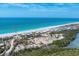 Aerial view of the property on a beautiful beach with stunning turquoise waters, and a nearby parking area at 7554 Palm Island S Dr # 1822, Placida, FL 33946