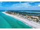 Stunning aerial shot of a beachfront property and the ocean, next to a strip of homes at 7554 Palm Island S Dr # 1822, Placida, FL 33946