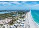 Panoramic aerial shot of beachfront real estate with pristine beaches and the ocean on one side at 7554 Palm Island S Dr # 1822, Placida, FL 33946