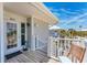 Beach house balcony with seating and stairs, offering stunning views of the beach and surrounding neighborhood at 7554 Palm Island S Dr # 1822, Placida, FL 33946