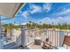 Charming outdoor balcony with seating that overlooks sandy surroundings, trees, and other beach homes at 7554 Palm Island S Dr # 1822, Placida, FL 33946