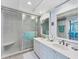 Bright bathroom featuring a double vanity, walk-in shower, and modern fixtures at 7554 Palm Island S Dr # 1822, Placida, FL 33946