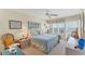 This serene bedroom features ocean views, a ceiling fan, and tropical decor at 7554 Palm Island S Dr # 1822, Placida, FL 33946
