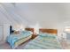 Bright bedroom with two beds, blue bedding, and overhead lighting at 7554 Palm Island S Dr # 1822, Placida, FL 33946