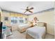Inviting bedroom with twin beds, a ceiling fan, and tropical decor at 7554 Palm Island S Dr # 1822, Placida, FL 33946