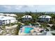 Aerial view of resort community featuring a sparkling pool, lush landscaping and luxurious condos at 7554 Palm Island S Dr # 1822, Placida, FL 33946