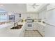 Bright kitchen with white cabinets, tiled floors, stainless steel appliances, and an undermount sink at 7554 Palm Island S Dr # 1822, Placida, FL 33946
