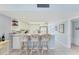 Open concept kitchen featuring a breakfast bar with seating, white cabinets, and views into the hallway at 7554 Palm Island S Dr # 1822, Placida, FL 33946
